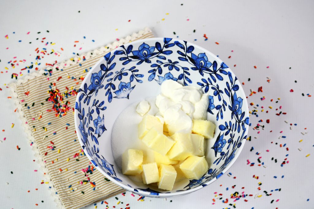 bowl of butter and sugar mixed for funfetti birthday crumb cake